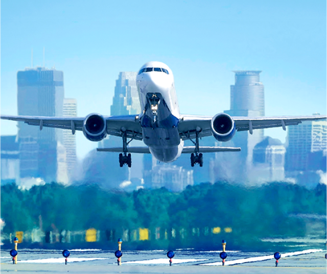 Plane with Minneapolis skyline in the background.