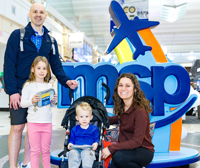 A family poses with a MSP monument.