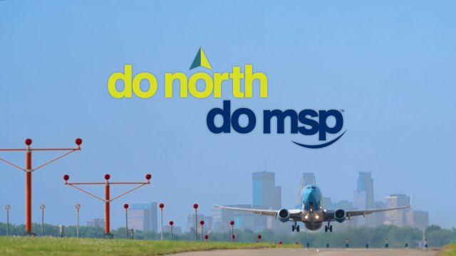 Do North. Do MSP. Aircraft taking off with Minneapolis skyline in the background.