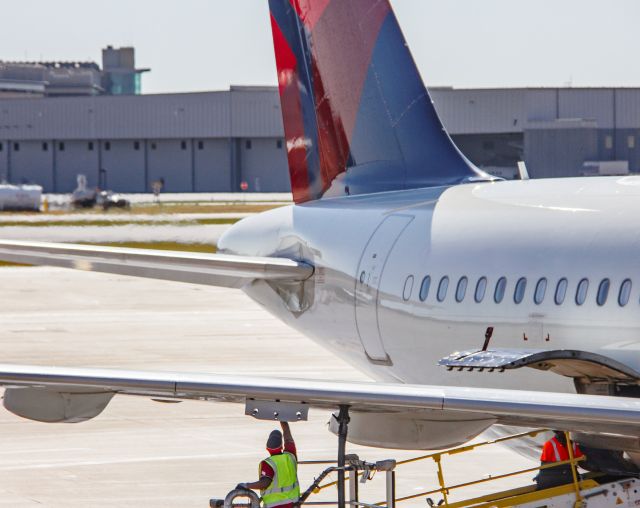 An employee working on the airplane that flew the first-ever flight fueled in part by sustainable aviation fuels from MSP Airport