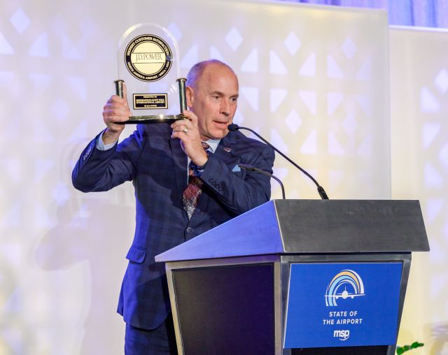 MAC CEO Brian Ryks displays MSP Airport’s 2024 J.D. Power award trophy for the top-ranking mega airport in customer satisfaction at the State of the Airport luncheon